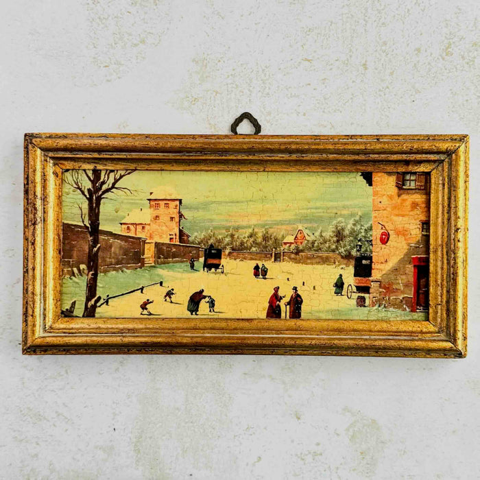 Vintage print of a winter village scene with people and animals in a rustic gold frame