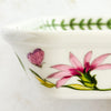 Left side profile of baking dish with floral and butterfly design