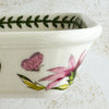 Right side profile of baking dish with floral and butterfly design