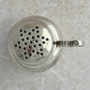 Top down view of silver shaker with lid on