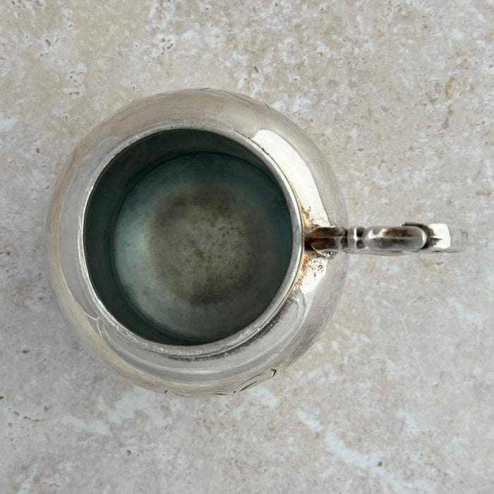 Top down view of silver shaker with lid off showing interior