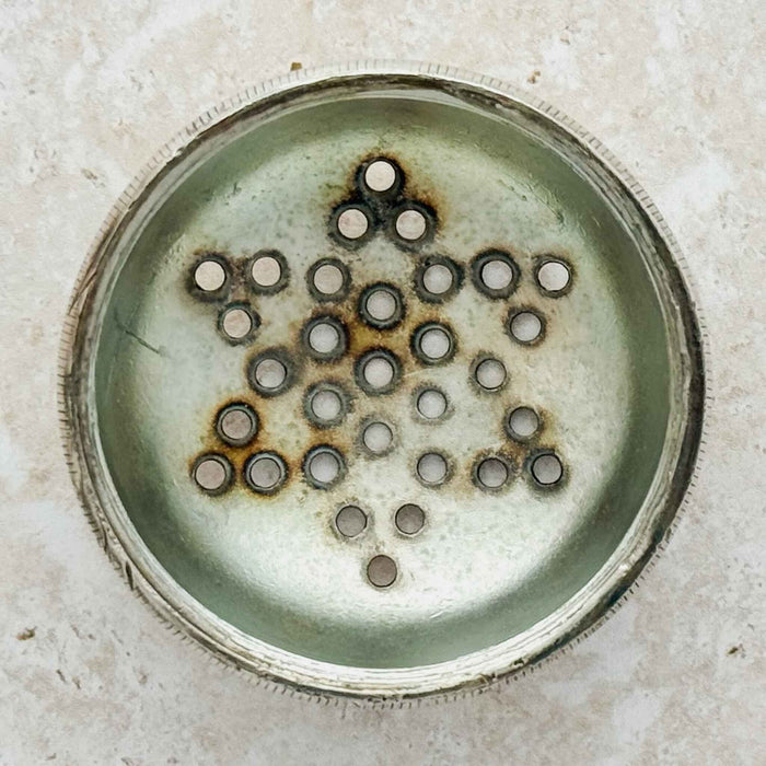 Close-up of interior lid discoloration on the silver sugar shaker