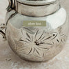 Close-up of the small area of silver loss above the embossed floral decoration
