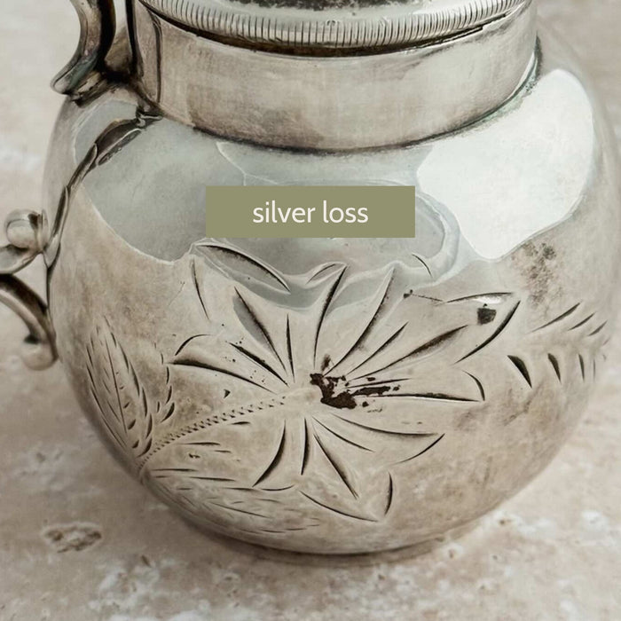 Close-up of the small area of silver loss above the embossed floral decoration
