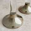 Close-up view of the base of a silver lucite candle holder