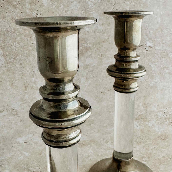 Staggered view of tops of the silver lucite candle holders