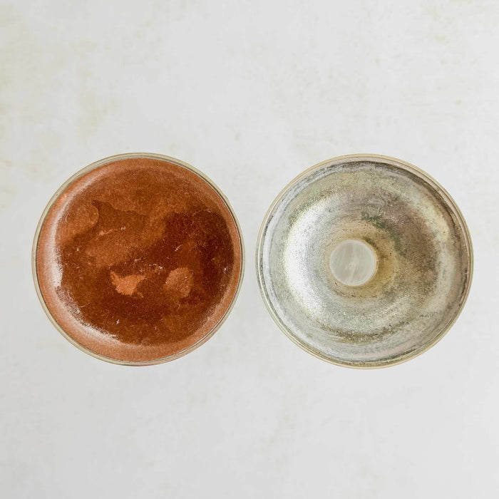 Undersides of silver and lucite candle holders