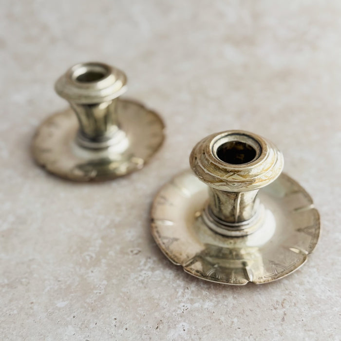 Staggered view of two Art Deco candle holders