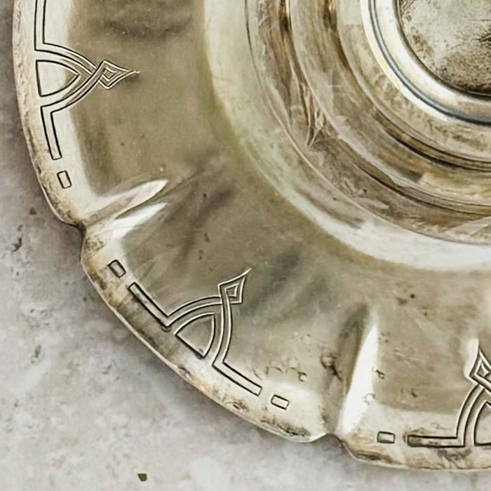 Close-up view of chased Art Deco patterns on candle holder