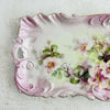 Close-up of left side of rose floral tray highlighting swired ruffled border