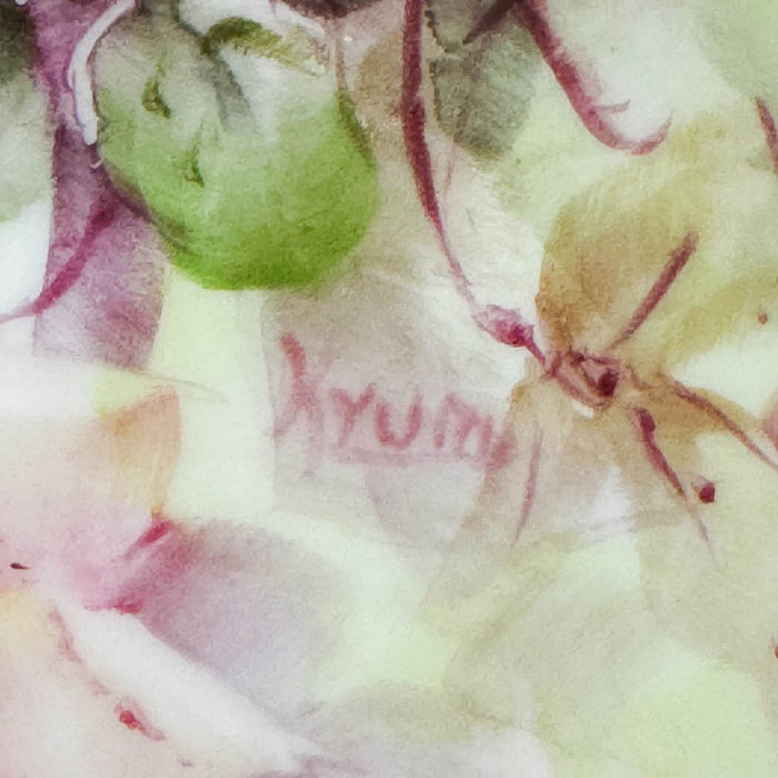 Close-up of artist signature painted in rose on the floral field of a vintage hand-painted porcelain tray