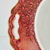 Close-up of cake plate handle cutout in pink and gold floral border
