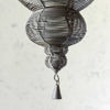 Close-up of drop finial and wire tassel on larger hanger