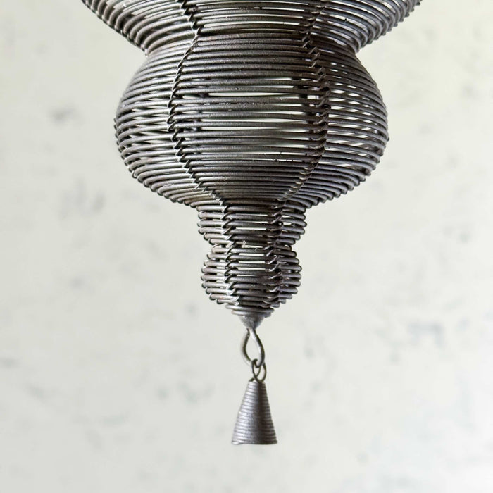 Close-up of drop finial and wire tassel on larger hanger
