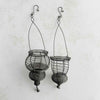 Profile view of hanging wire baskets side by side on a light background