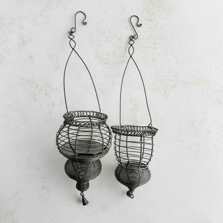 Profile view of hanging wire baskets side by side on a light background