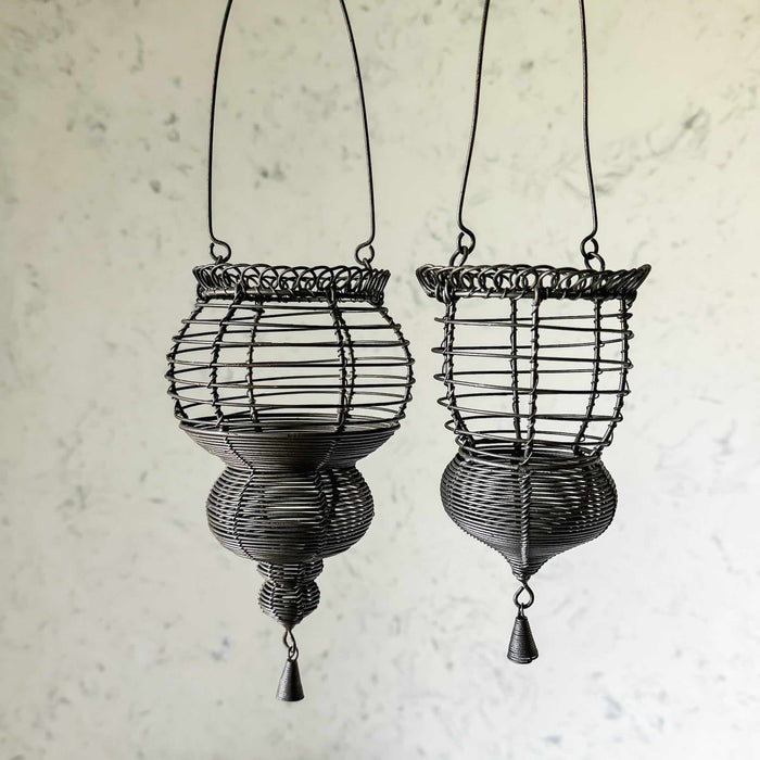 Profile view of two hanging wire baskets