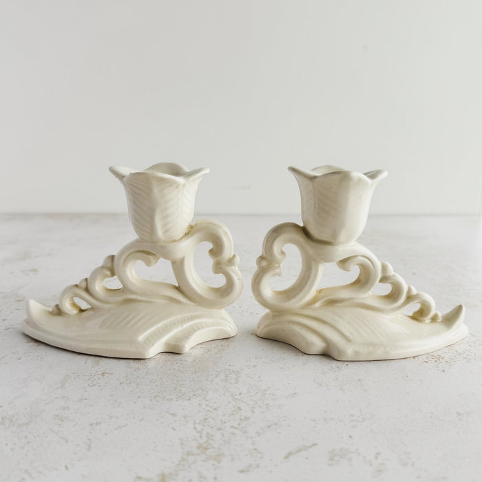Side profile view of pair of Art Deco candle holders