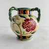 Side view of the violet flower on the Maruhon majolica vase