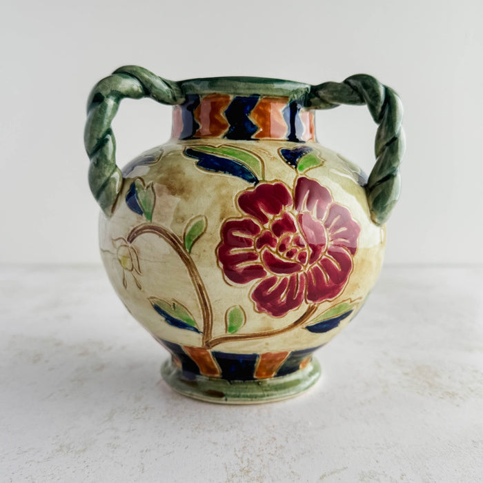Side view of the violet flower on the Maruhon majolica vase