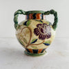 Side view of the purple flower on the Maruhon majolica vase