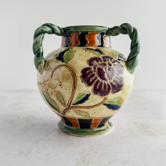 Side view of the purple flower on the Maruhon majolica vase