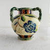 Side view of the navy blue flower on the Maruhon majolica vase