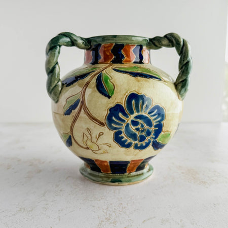 Side view of the navy blue flower on the Maruhon majolica vase