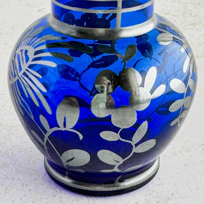 Close-up of floral silver overlay on vase