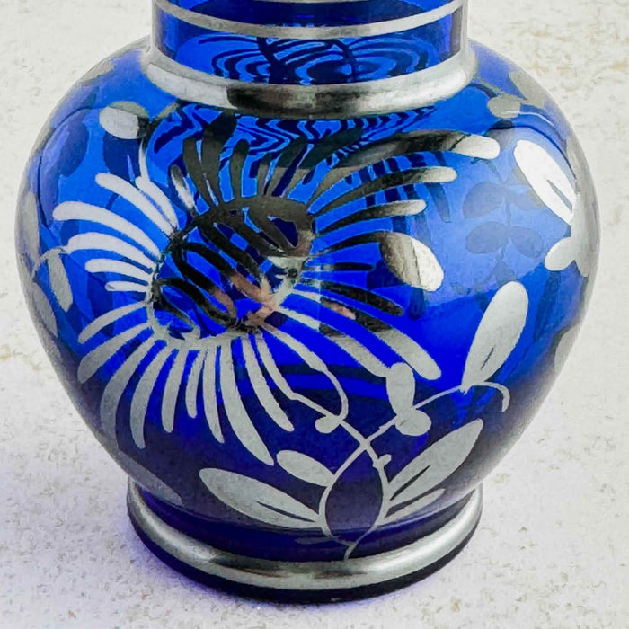 Close-up of floral silver overlay on vase