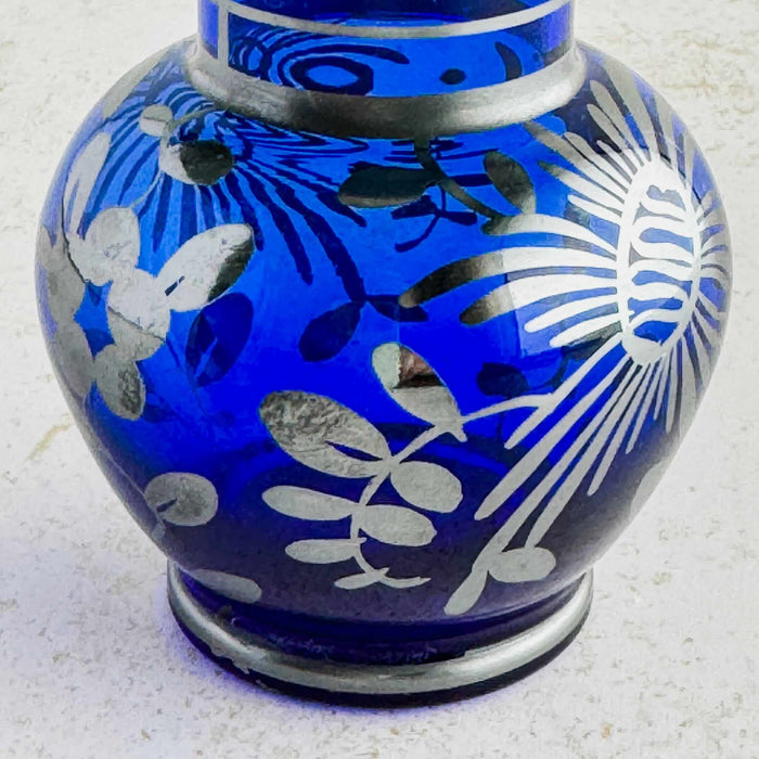 Close-up of floral silver overlay on vase