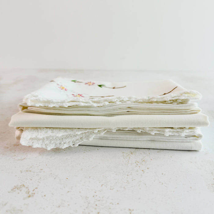 Stacked folded embroidered pillowcases - End view