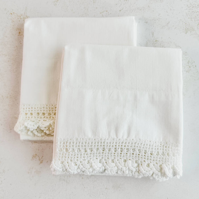 Pair of folded vintage white cotton queen size pillowcases