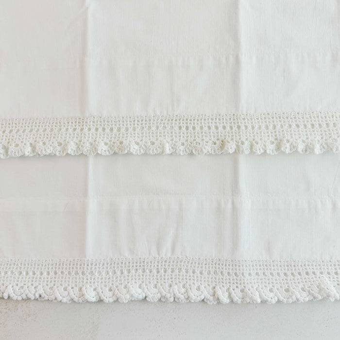 Unfolded pillowcases showing crochet lace edgings