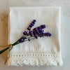 Stacked folded pillowcases styled with bundle of lavender