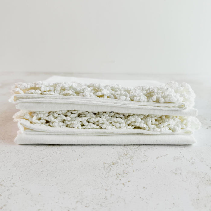 Stacked folded pillowcases showing lace edging - end view