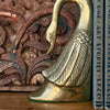 Styled shot of swan bookend with books against carved wood panel