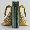 Pair of Mid-Century brass swan bookends styled with books against a light background