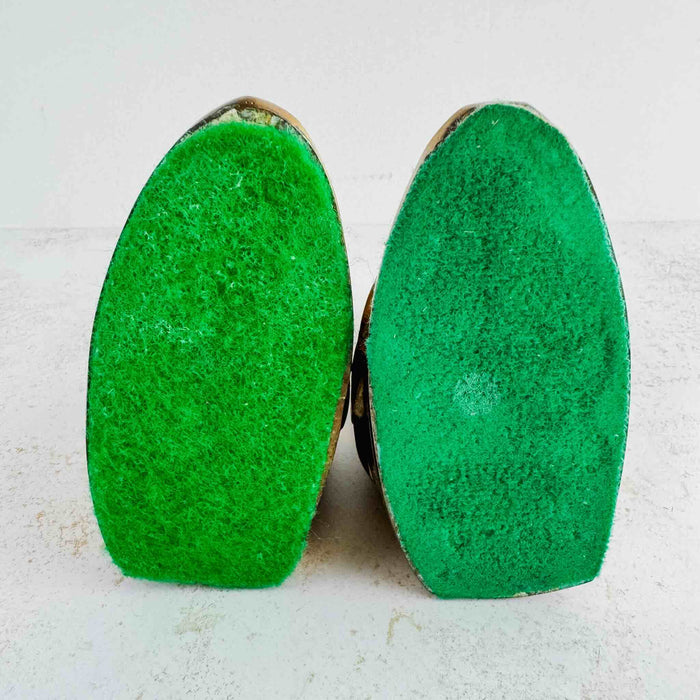 Bottoms of swan bookends showing the green felt