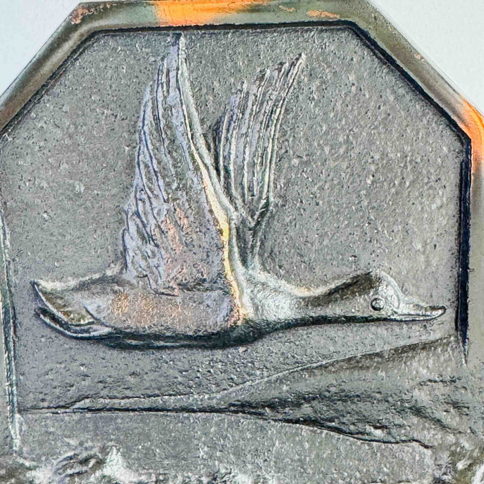 Close-up of duck in flight relief on bookend