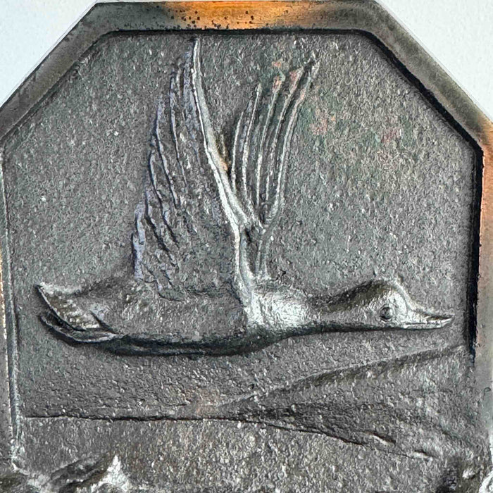 Close-up of duck in flight relief on bookend