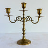 Vntage mid-century 3-candle brass candelabra against a light background