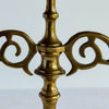 Closeup of two scroll arms attached to central stem of candelabra