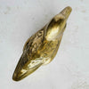 Top view of vintage brass duck figurine showing body shape, wing details, and elongated form