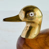 Close-up of brass duck head showing inlaid eye