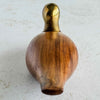 Wood and brass duck facing away