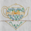 Close-up of yellow teapot embroidery