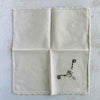 Front of unfolded cocktail napkin
