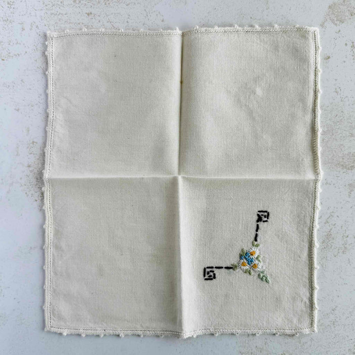 Front of unfolded cocktail napkin