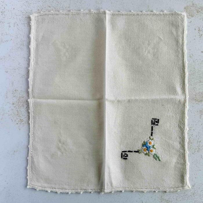 Front of unfolded cocktail napkin